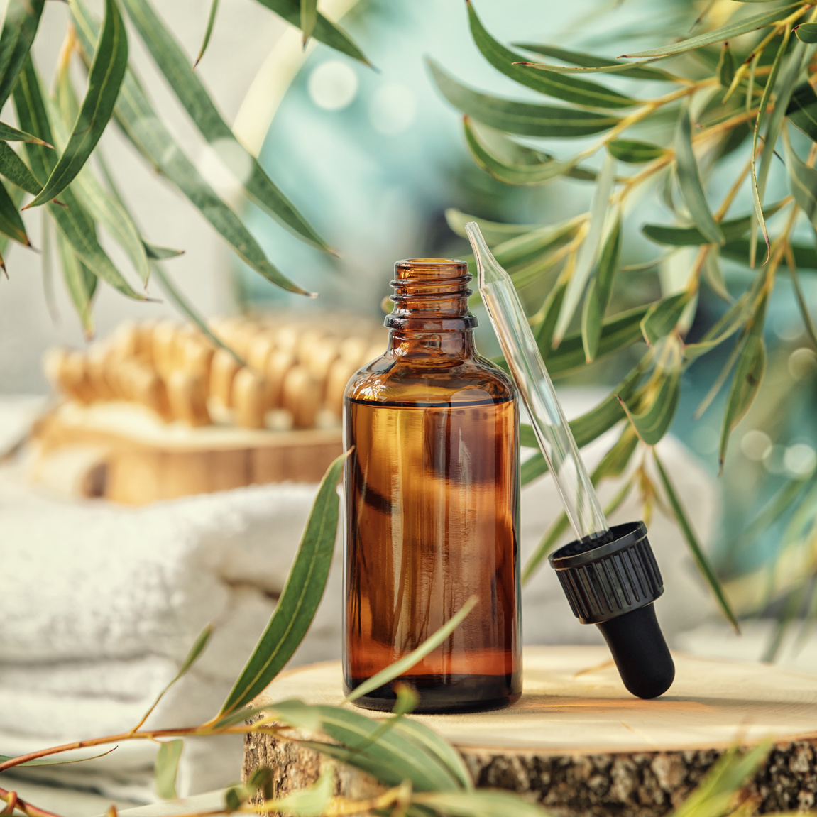 Essential Oil Bottle with Pipette and Eucalyptus Leaves